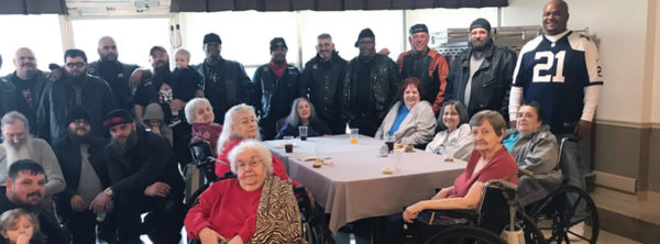 residents posed with motorcycle club members