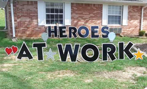 Heros at Work sign in front of a brick home