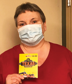 One of Madison's employee appreciation recipients holding a Texas Roadhouse giftcard