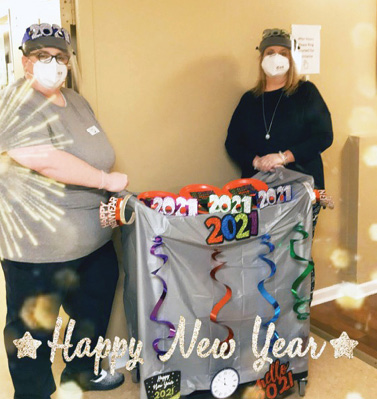 two Madison Health and Rehab staff members with cart of goodies