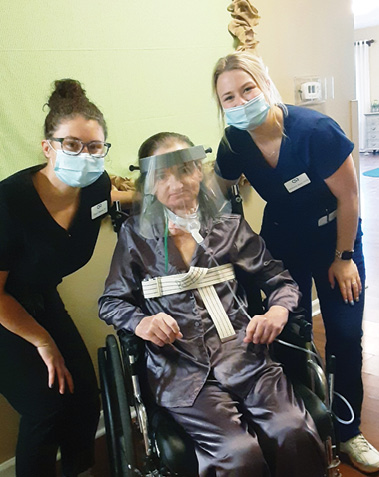 Madison Health and Rehab resident Sandra pictured with two female staff members