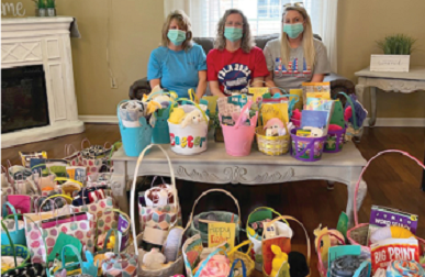3 women pictured with 70 donated Easter baskets