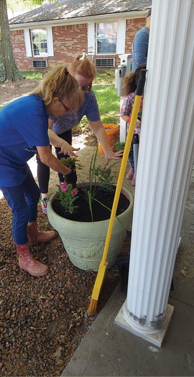 volunteers helping to plant flowers at Madison Health and Rehab