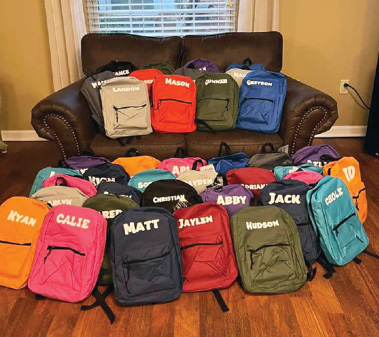 backpacks displayed on sofa
