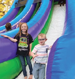 two children standing on inflatable jumping castle