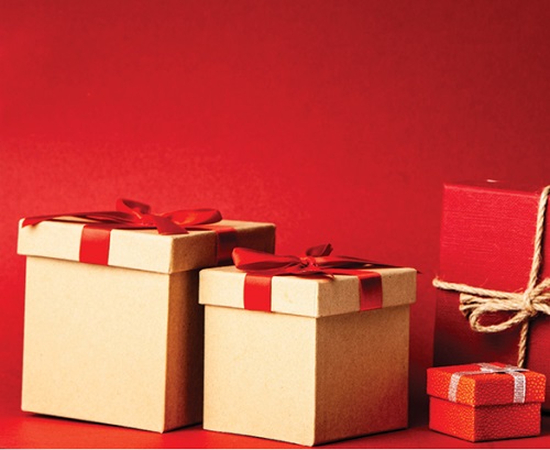 Brown and red gift boxes tied with ribbon and twine placed on red background
