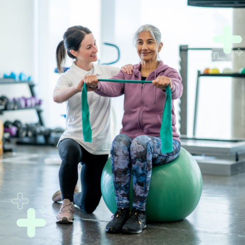 Older adult woman working with physical therapist in the gym